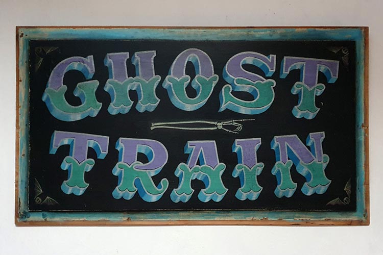 Ghost Train sign painted in Tuscan lettering by Jill Strong